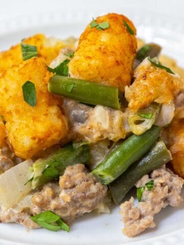 Green bean tater tot casserole with ground beef and cheddar cheese.