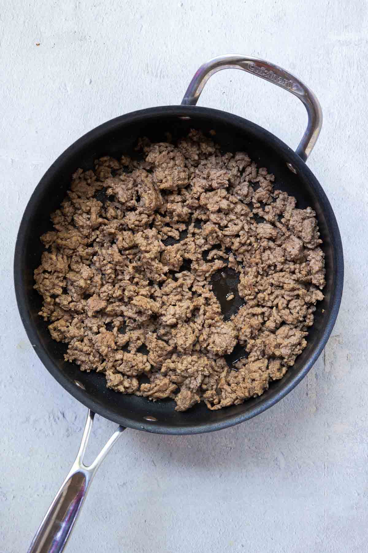 Browned ground beef in a large skillet.