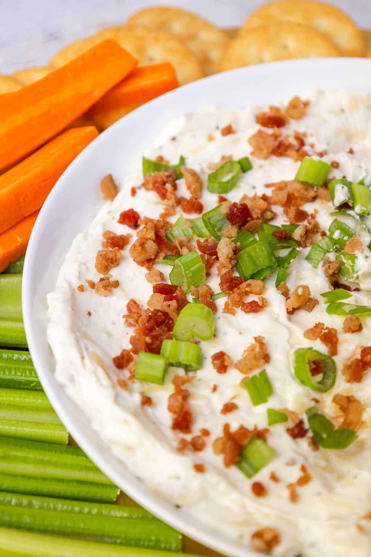 Gouda cheese dip topped with bacon bits and green onion.