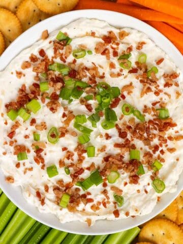 Smoked gouda cheese dip topped with bacon bits and green onion.