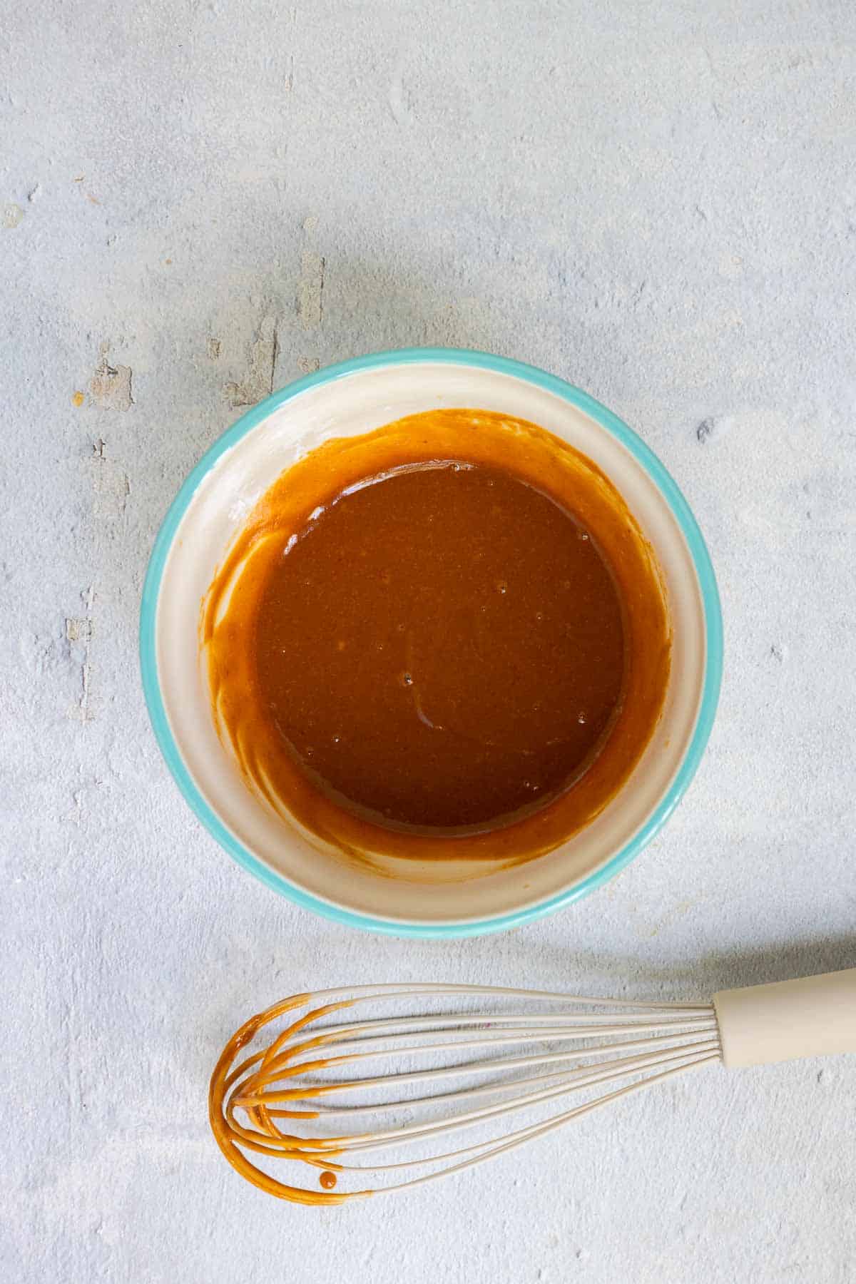 Peanut sauce whisked until smooth in a small mixing bowl.