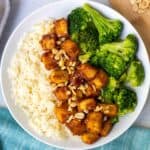 Peanut butter tofu served with rice and broccoli.