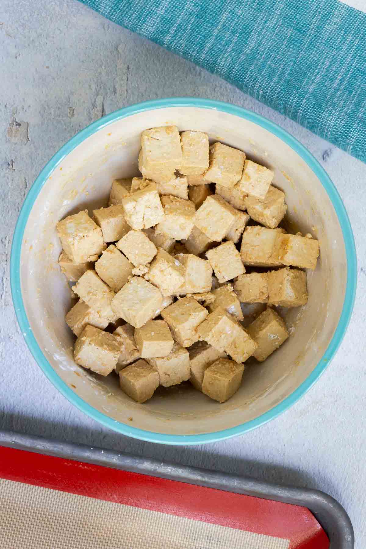 The marinated tofu is evenly coated in corn starch.