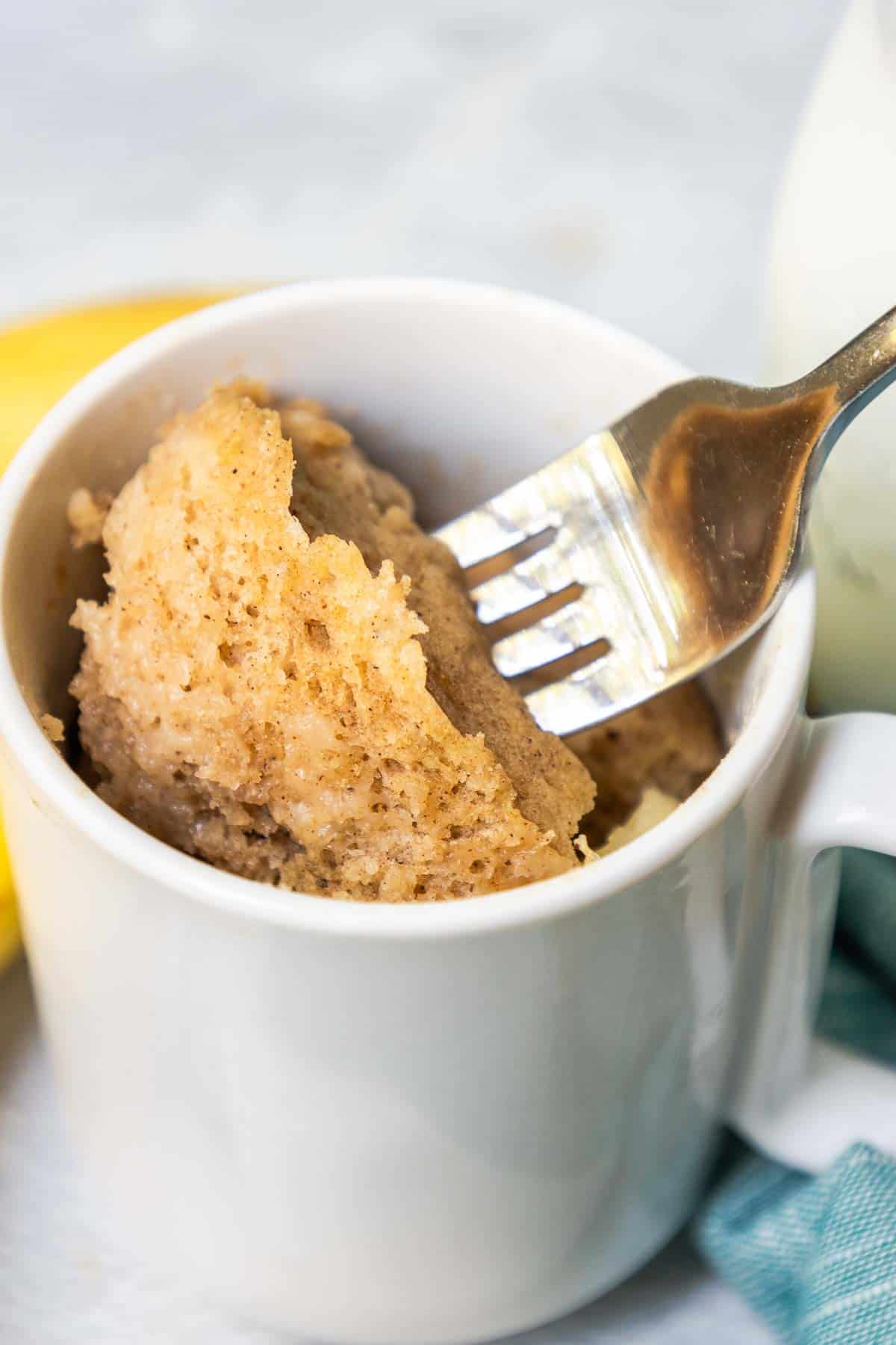 A bite of banana mug cake on a fork to show the banana bread-like texture.