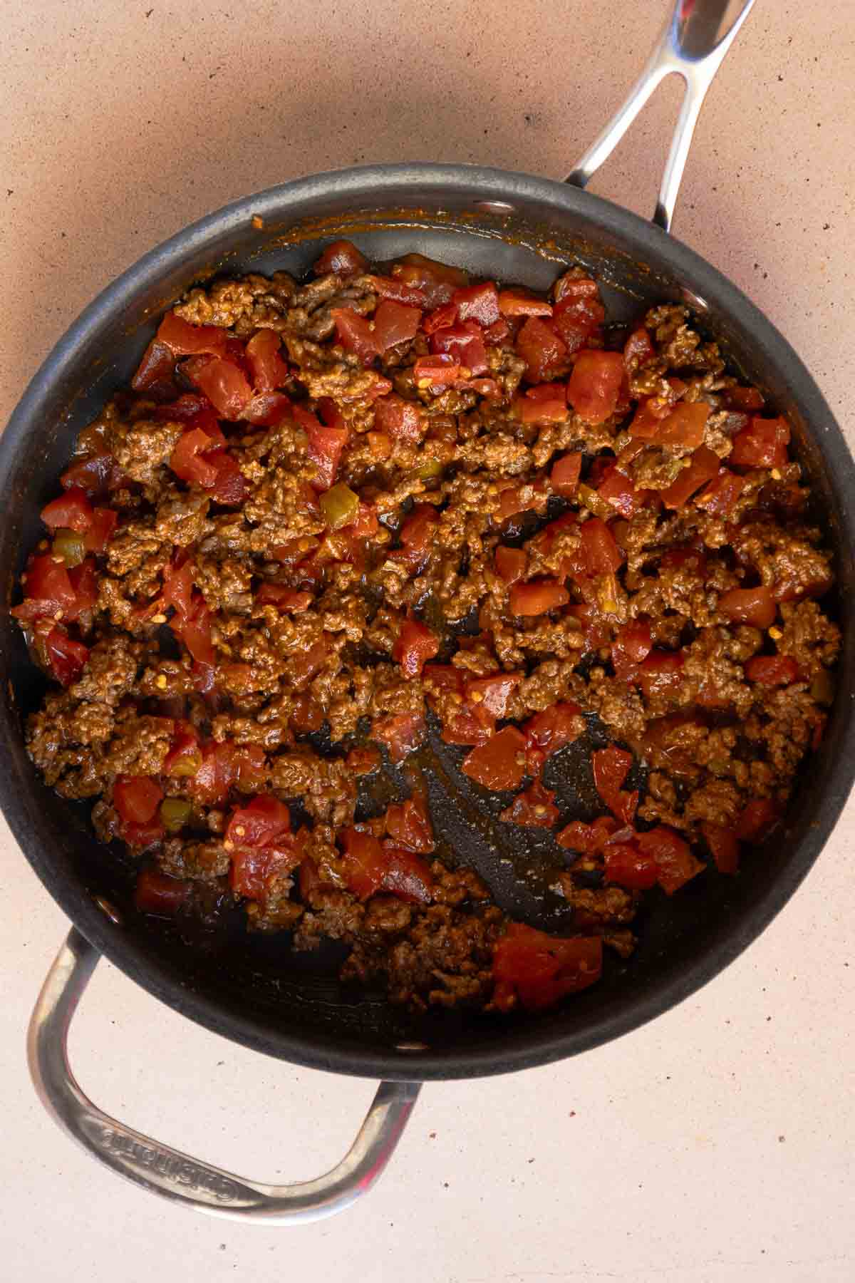 The ground beef and Rotel are mixed together in the large saucepan.