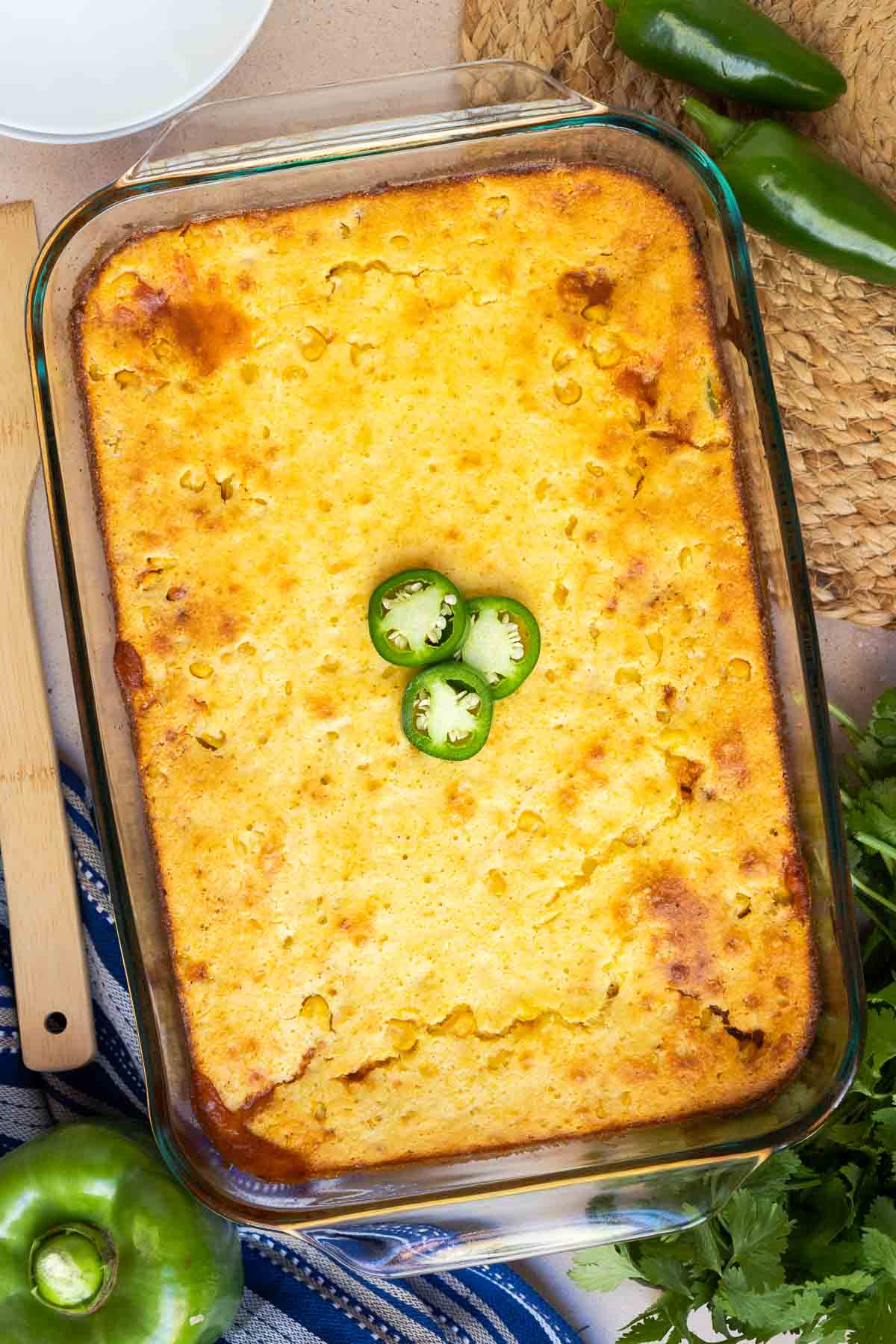 Chili cornbread casserole baked until golden brown and topped with fresh jalapeño.