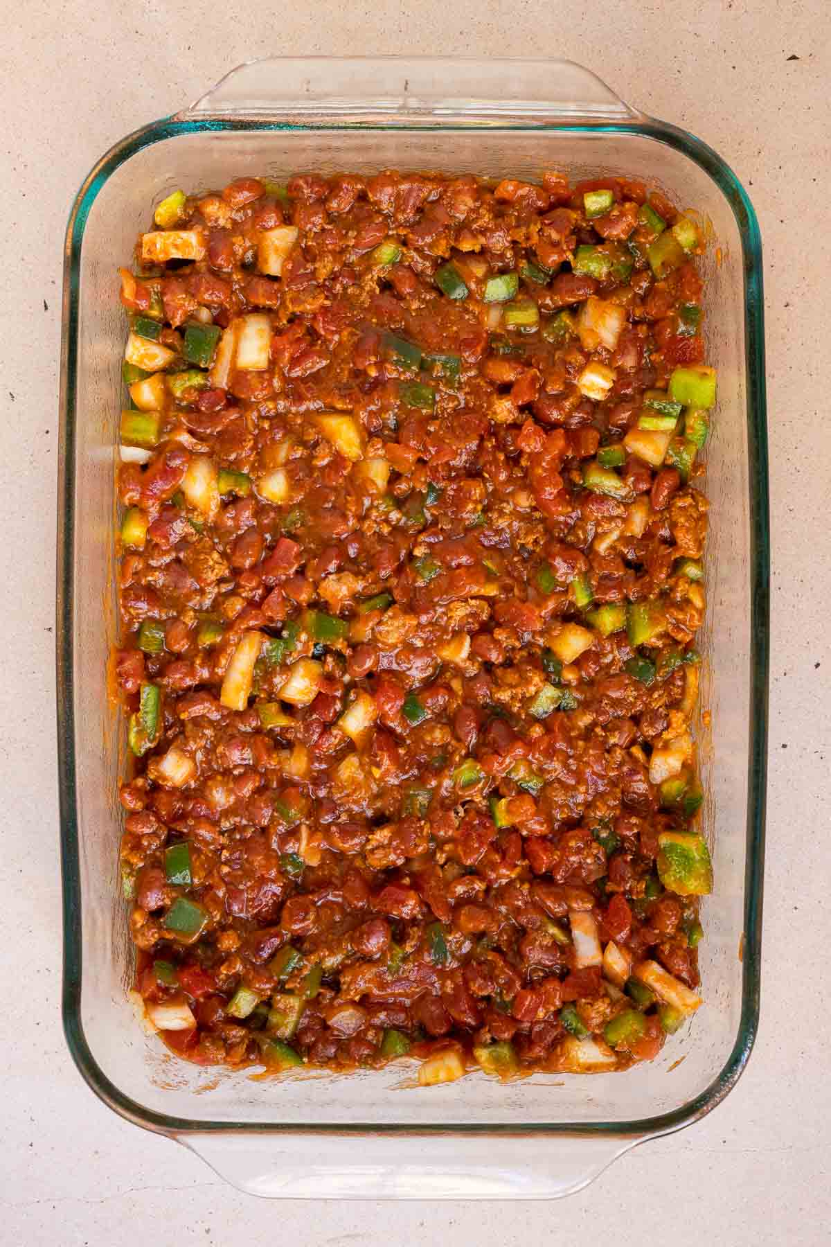 The canned chili and diced veggies are mixed together.