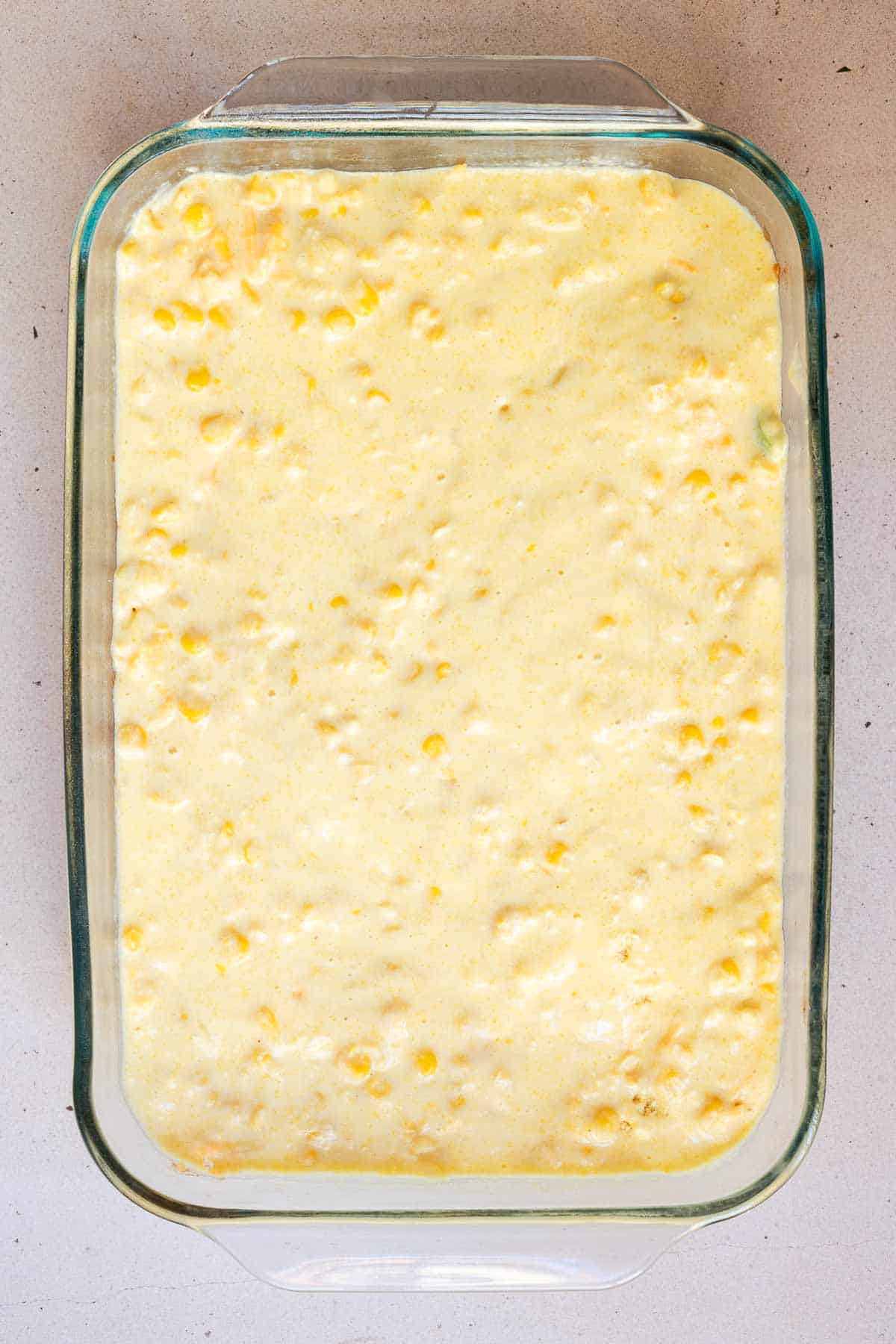 The cornbread mixture is pour in an even layer over top of the chili.