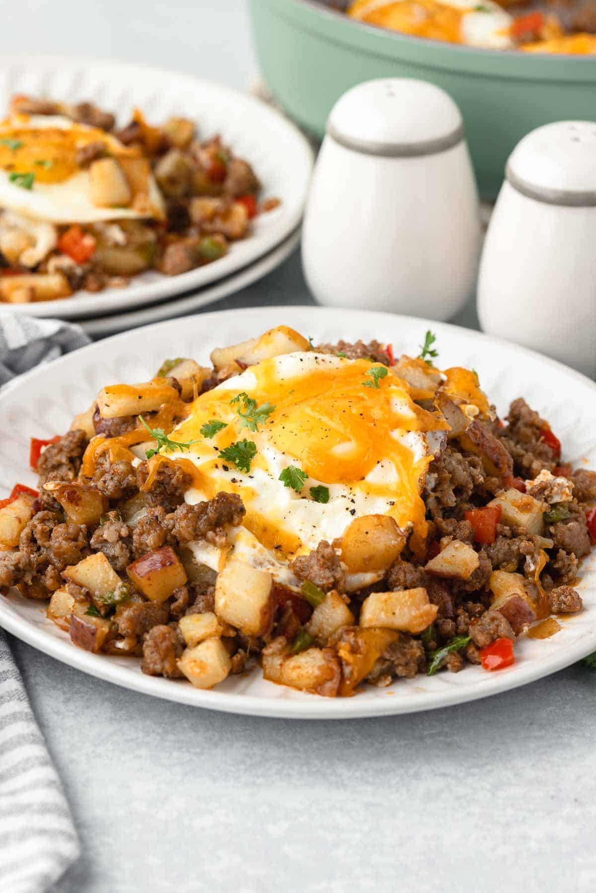 Breakfast sausage potato hash with eggs and cheese.