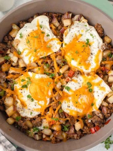 Breakfast sausage potato skillet with eggs and cheese.
