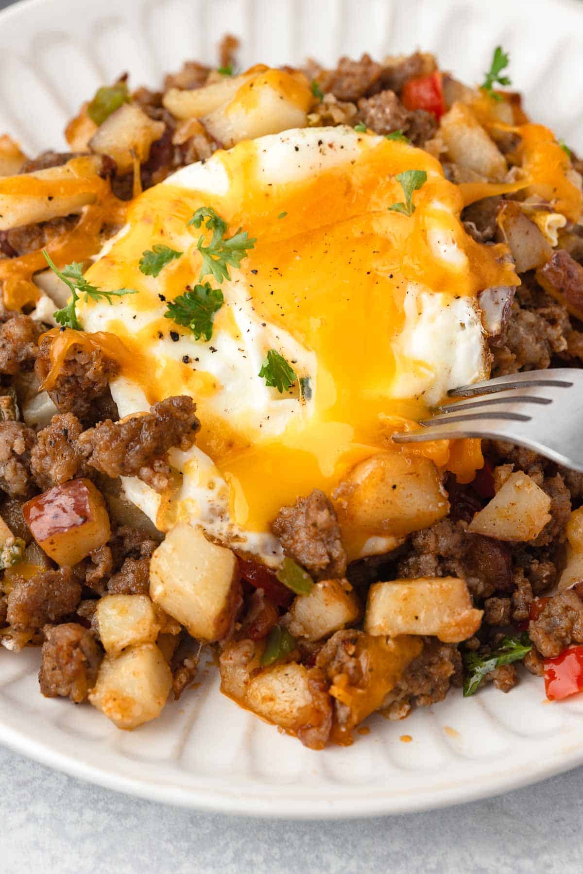 The breakfast sausage potato skillet is made with eggs cooked with a runny yolk.