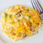 Potato chip chicken casserole is served on a plate and garnish with fresh parsley.