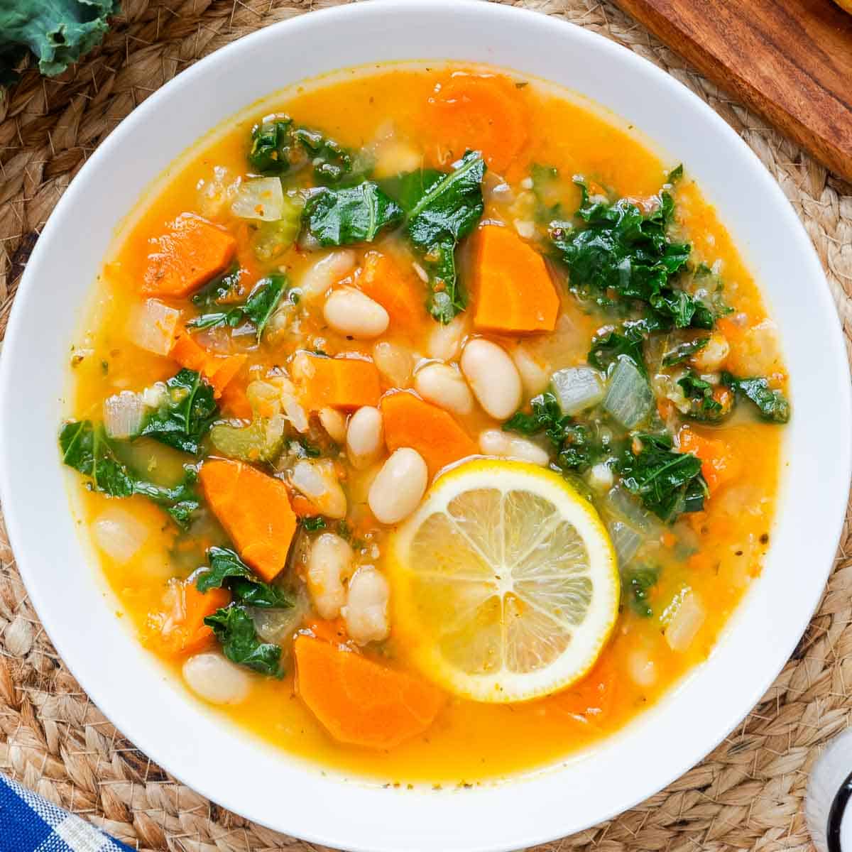 White bean soup with lemon and kale in a small bowl.