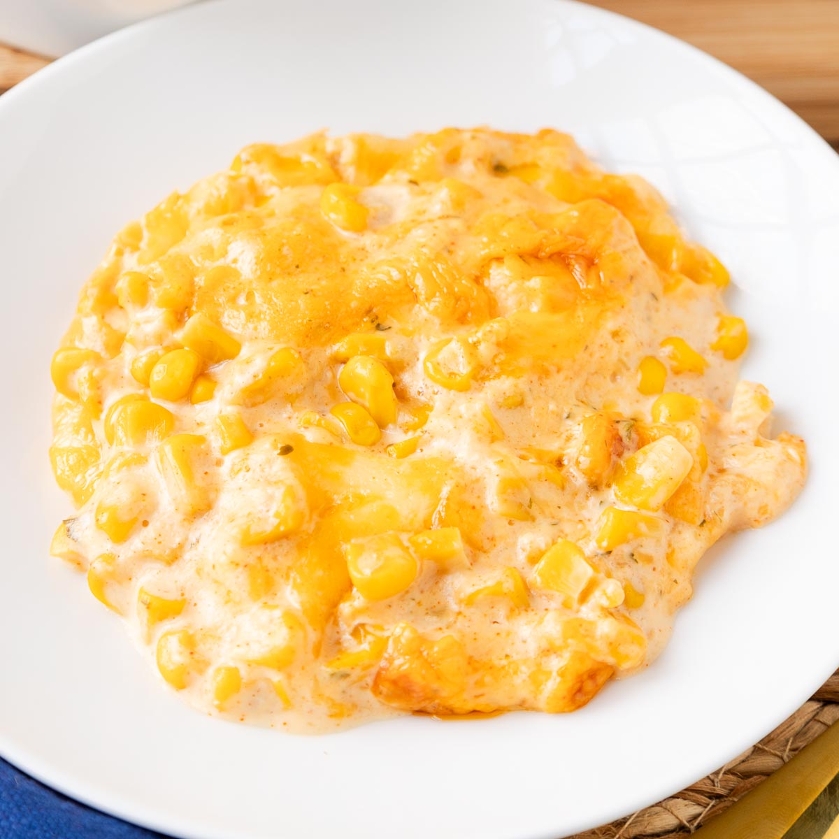 creamy and cheesy corn casserole served on a small side dish.