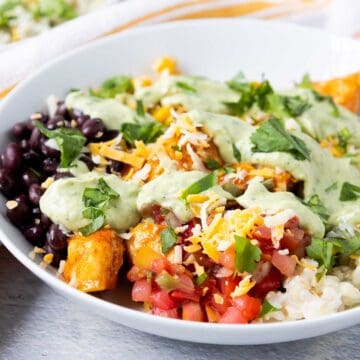 Southwest chicken rice bowls with pico de gallo, cilantro lime rice, black beans, corn, cheese, and avocado dressing