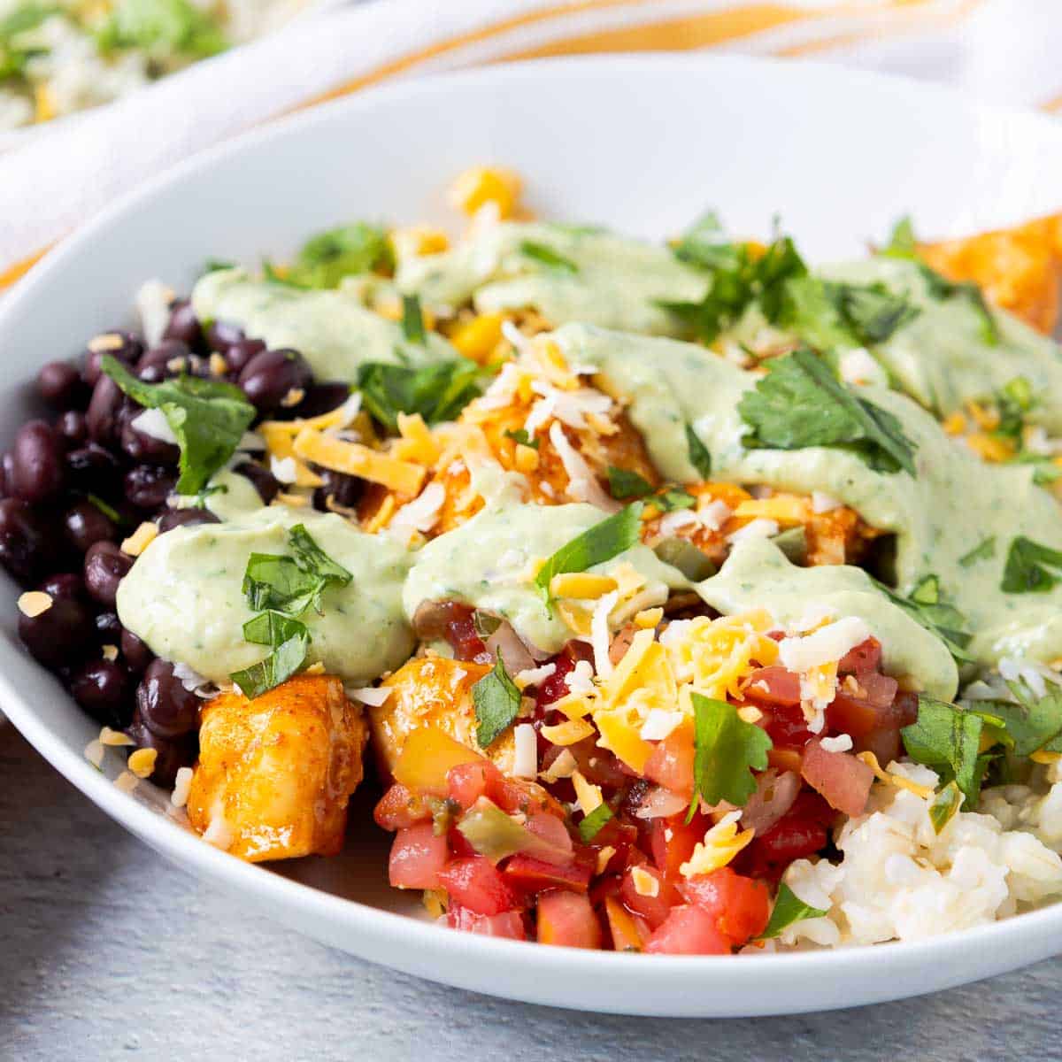 Southwest chicken bowls with rice, pico de gallo, black beans, corn, and cheese.