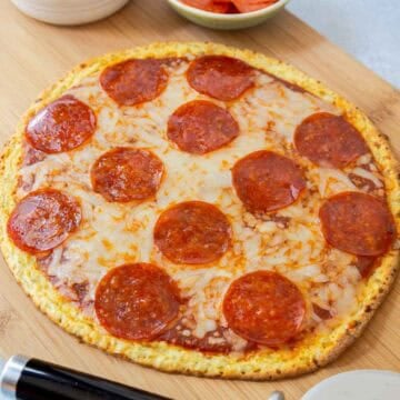 Cottage cheese pizza crust topping with shredded mozzarella and pepperoni.