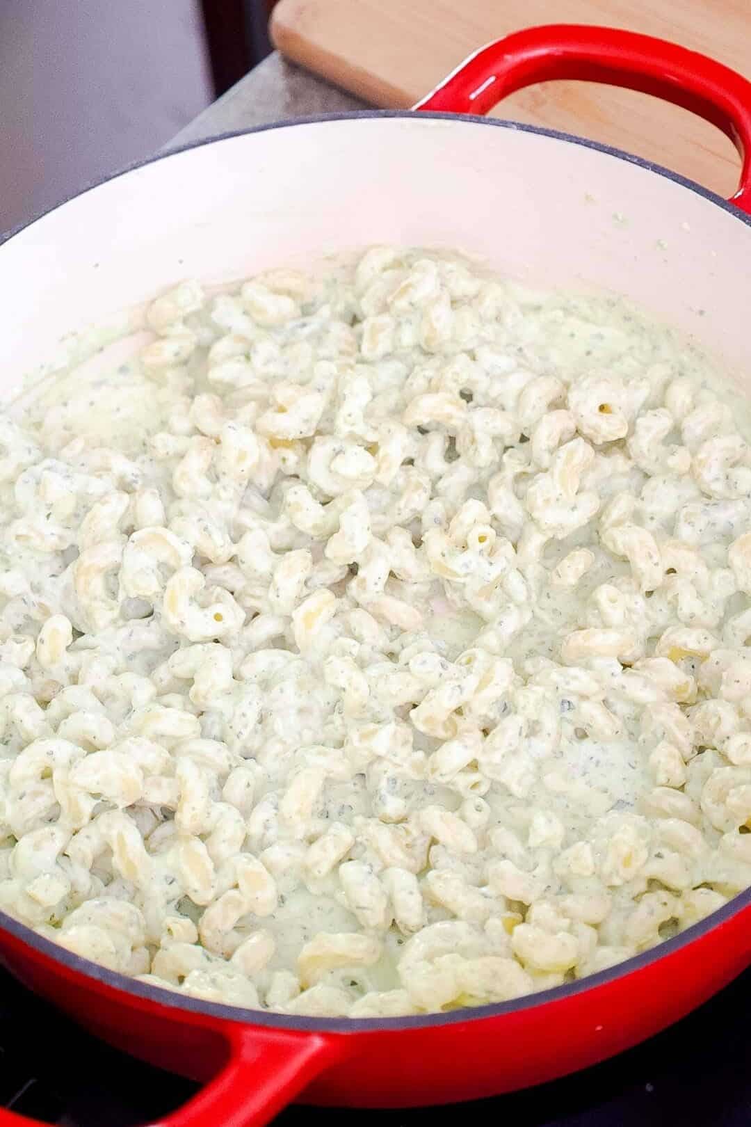 Pasta stirred into creamy jalapeño ranch sauce in a large pot.