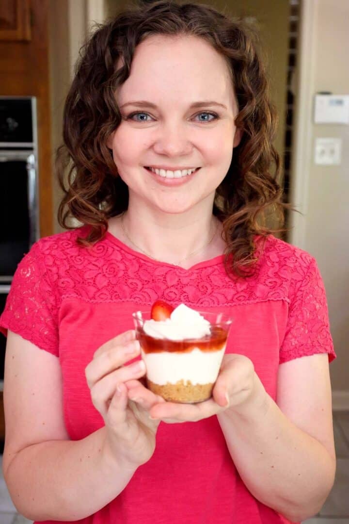 Kelsey Smith holding a strawberry cheesecake cup.